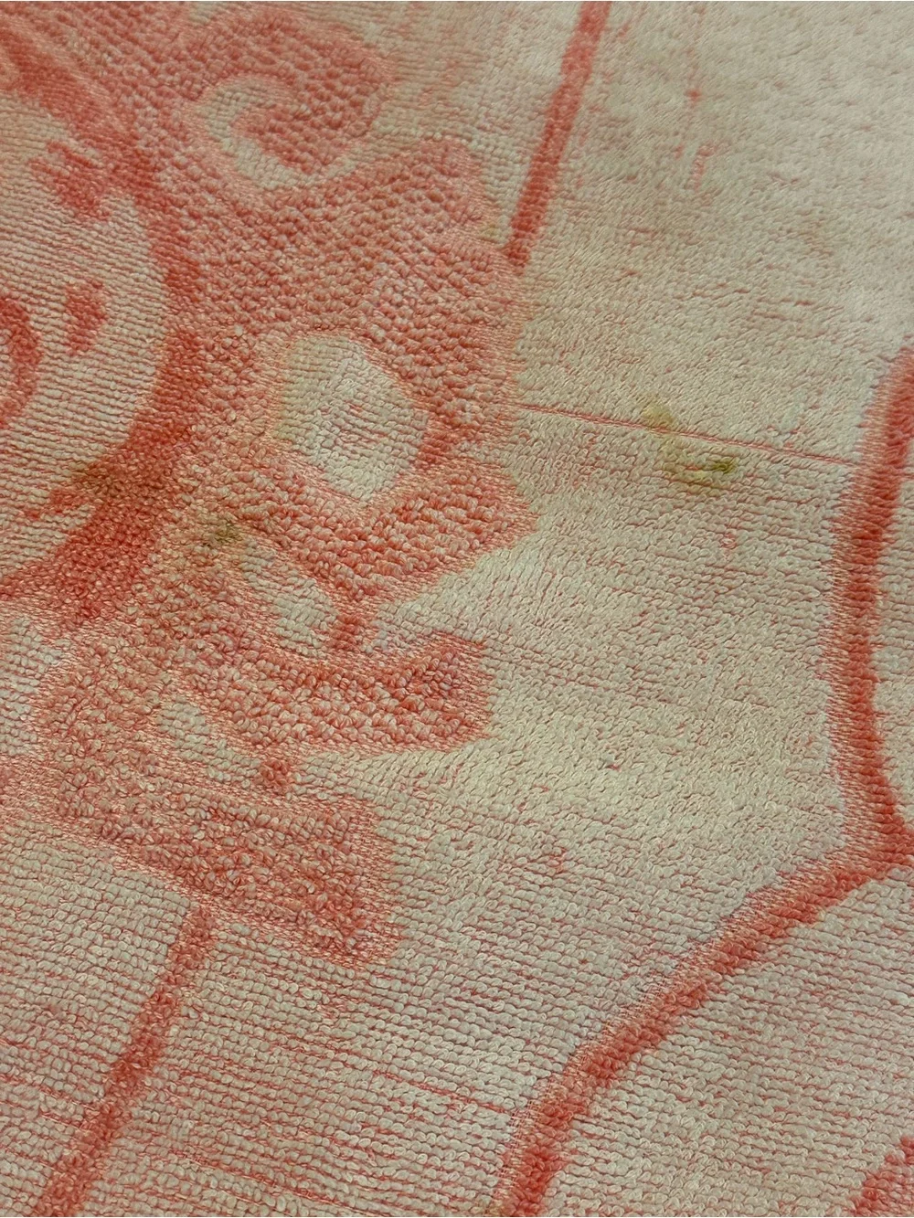 Pink and white 70s beach towel featuring Punchy, the Hawaiian Punch Mascot